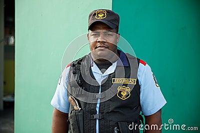 2022.12.03 Dominican Republic provinces La Altagracia. A male security guard armed with a pistol. Dominican people. Editorial Stock Photo