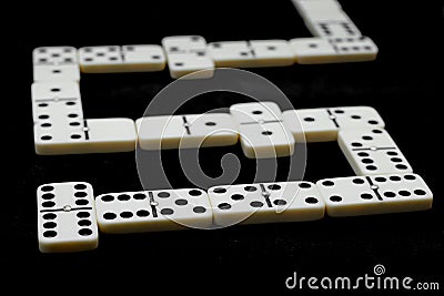 Domino match. Over black table and selective focus. Stock Photo