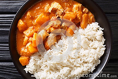 Domoda is the national dish of Gambia, a peanut stew made with meat pumpkin and served over fluffy rice close-up in a plate. Stock Photo