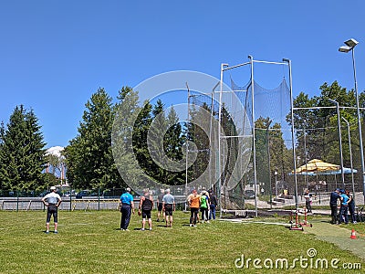 DOMZALE, SLOVENIA. 13.6.2020 Group of elderly athletes, waiting to compete in a throwing event Editorial Stock Photo