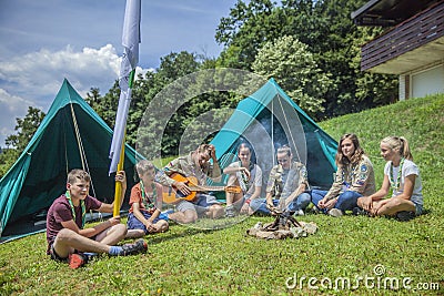 DOMZALE, SLOVENIA - Jul 16, 2019: Sitting around a fire and singing songs Editorial Stock Photo