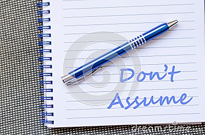 Don't assume write on notebook Stock Photo