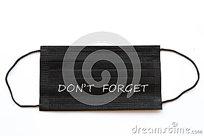Don`t forget message note on black mask prevent infection covid 19 Stock Photo