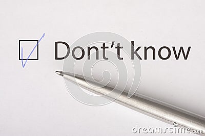 Don`t know - checkbox with a tick on white paper with metal pen. Checklist concept Stock Photo