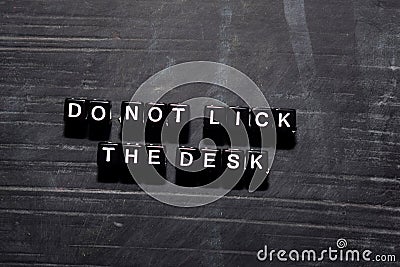 Don`t lick the desk on wooden blocks. Education, Motivation and inspiration concept Stock Photo