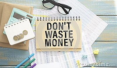 don`t waste money, text on white notepad paper on gray background. business concept. Stock Photo