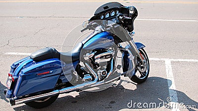 A blue Harley Davidson motorcycle waits for its owner. Editorial Stock Photo