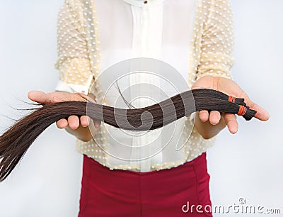 Donate hair to cancer patient, Close up woman hands holding hairline Stock Photo