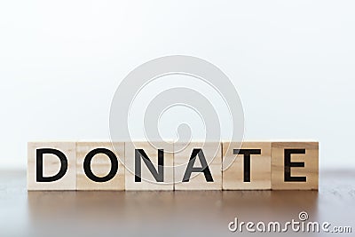 Donate word written on wooden cubes Stock Photo