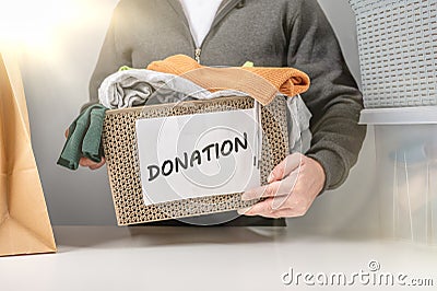 Donation concept. Donation box with donation clothes. Helping poor and needy people. box for poor with clothing in male hands. Stock Photo