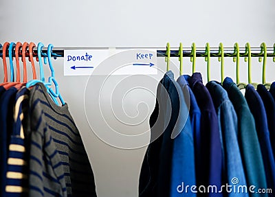 Donation Concept. Separated Used Old Clothes from Wardrobe Rack to Keep and Donate Stock Photo