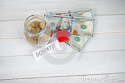 Donations and Charity. Donation Concept. Glass with Donations on White Background. Inscription Donate. Charity and Money Stock Photo