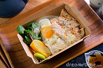 Donburi Chicken served in a Japanese restaurant in Tokyo . Japanese combo dish with chicken, rice, egg, and vegetables. Stock Photo