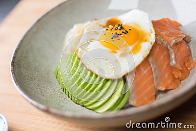 Donburi Salmon served in a Japanese restaurant in Tokyo . Japanese combo dish with chicken, rice, egg, and vegetables. Stock Photo