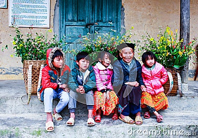 VAN, HA GIANG, VIETNAM, November 18th, 2017: Unidentified ethnic minority kids with baskets of rapeseed flower in Hagiang. Editorial Stock Photo