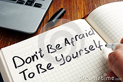 Dont be afraid to be yourself handwritten in a note. Motivation quote Stock Photo