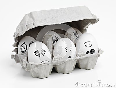 Dont close the lid, were afraid of the dark. Studio shot of faces drawn onto a carton of eggs. Stock Photo