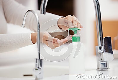 Dont forget to use soap. Shot of an unrecognizable person washing her hands with soap at home. Stock Photo