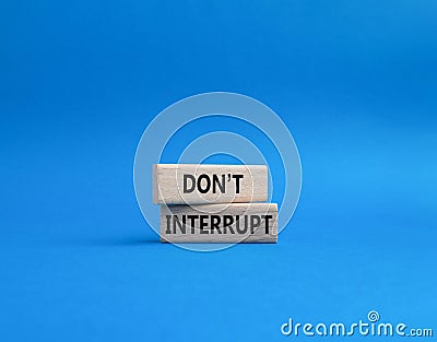 Dont interrupt symbol. Concept word Dont interrupt on wooden blocks. Beautiful blue background. Business and Dont interrupt Stock Photo