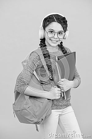 Dont stop the lesson. Little girl wear headphones. Happy child back to school. Private lesson. Listening comprehension Stock Photo