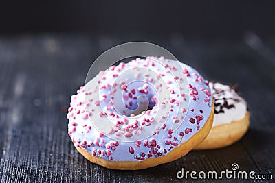 Donuts with blue and vanilla icing on a dark background Stock Photo