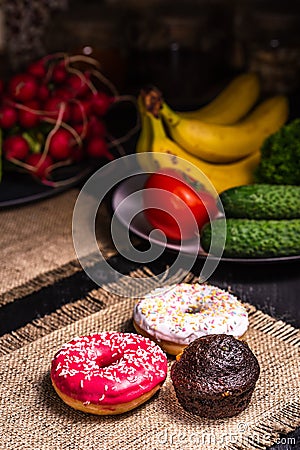 Donuts and chocolate muffin on burlap Stock Photo