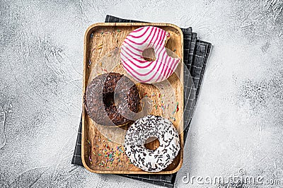 Donuts with chocolate, pink glazed and sprinkles Doughnut. White background. Top view Stock Photo