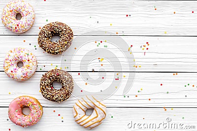 Donuts decorated icing and sprinkles on white background top view copy space space for text Stock Photo