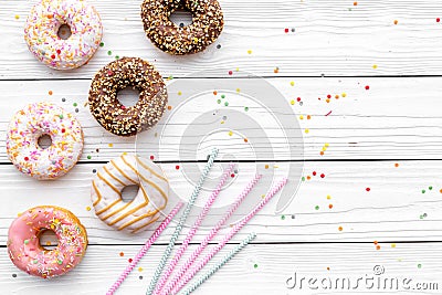 Donuts decorated icing and sprinkles on white background top view copy space space for text Stock Photo