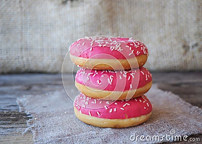 Donuts with pink frosting on the table Stock Photo