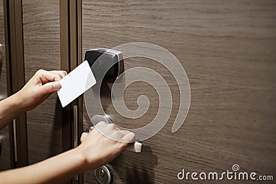 Door access control with a hand inserting key card to unlock door Stock Photo