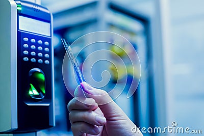 Door access control. Staff holding a key card to lock and unlock door at control room or data center Stock Photo