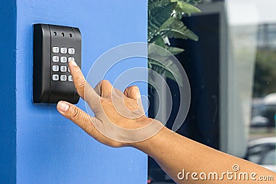 Door access control - young woman holding a key card to lock and unlock door., Keycard touch the security system to access the doo Stock Photo