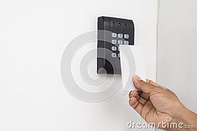 Door access control - young woman holding a key card to lock and unlock door., Keycard touch the security system to access the doo Stock Photo