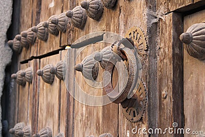 Door with an ancient caller in the medieval Spanish city of Segovia Stock Photo