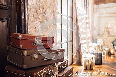 The door and the bag. Vintage used travel suitcases. Many old vintage suitcase. Luggage concept Stock Photo