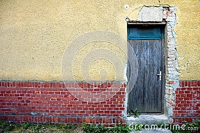 Door in brick and plaster wall Stock Photo