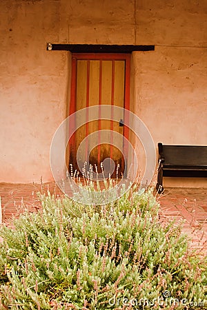 Door and bush at Mission San Miguel Arcangel Stock Photo