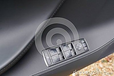 Door control panel in a new modern car electric window button Stock Photo