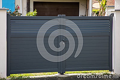 door grey double steel gate aluminum portal of home suburbs house in city Stock Photo