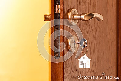 Door handle with inserted key in the keyhole and house icon on it Stock Photo