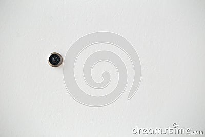 Door hole or peephole on white wooden door Stock Photo