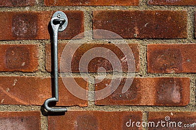 Door hook hanging on a brick wall Stock Photo