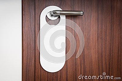 Door of hotel room with empty sign do not disturb Stock Photo