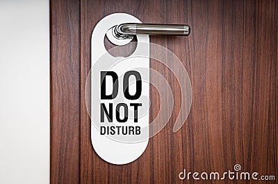 Door of hotel room with sign do not disturb Stock Photo