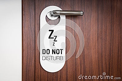 Door of hotel room with sign do not disturb Stock Photo