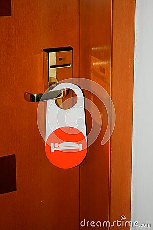 Door of hotel room with sign please do not disturb Stock Photo