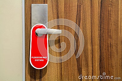 Door of hotel room with sign please do not disturb. Stock Photo