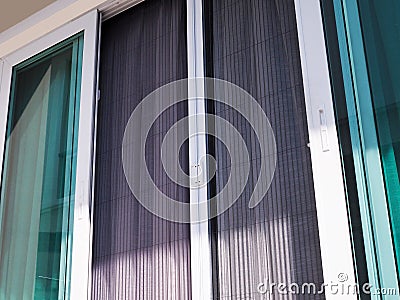 Door house white frame with mosquito net wire screen to prevent insects and mosquitoes Stock Photo