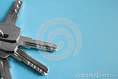 Door key lies on blue background. Set of keys. Bunch of keys. House key. New house concept. Rental and Selling. Stock Photo